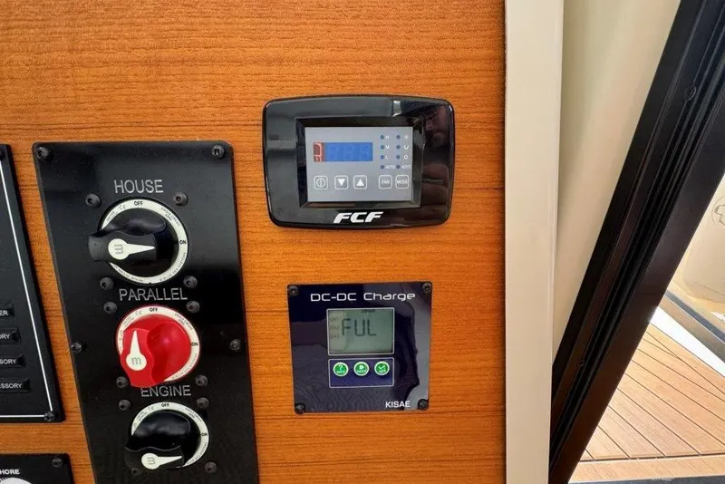 Slide: The Image of Control panel of 2022 Ranger Tugs R-27 with battery switches and DC-DC charger display. - 31