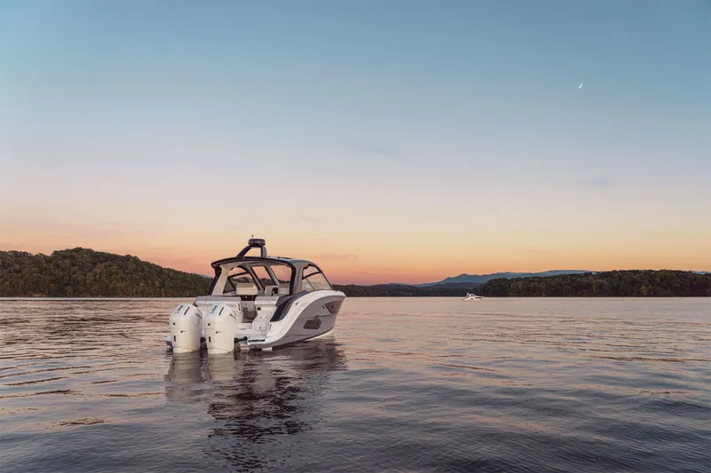 Slide: The Image of Sea Ray Sundancer 370 Outboard on calm water at sunset. - 39