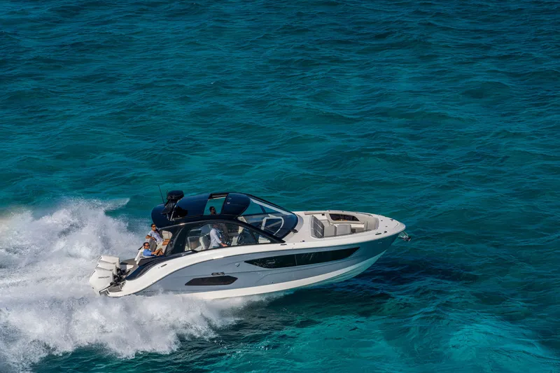 Slide: The Image of Sea Ray Sundancer 370 Outboard from 2026 gliding over turquoise water. - 14