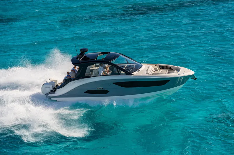 Slide: The Image of Sea Ray Sundancer 370 Outboard 2026 on turquoise water, featuring sleek design and luxurious interior. - 1