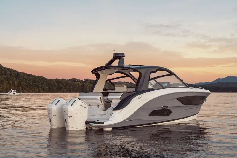 Slide: The Image of The 2026 Sea Ray Sundancer 370 Outboard glides on calm water at sunset. - 38