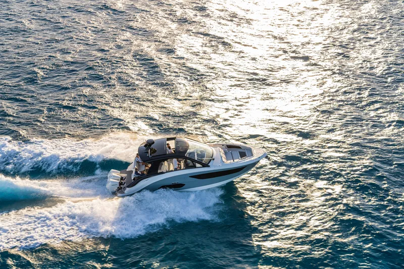 Slide: The Image of 2026 Sea Ray Sundancer 370 Outboard cruising on open water at sunset. - 13