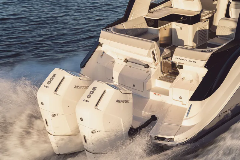 Slide: The Image of The image shows a Sea Ray Sundancer 370 Outboard boat with two Mercury 600 HP engines. - 5