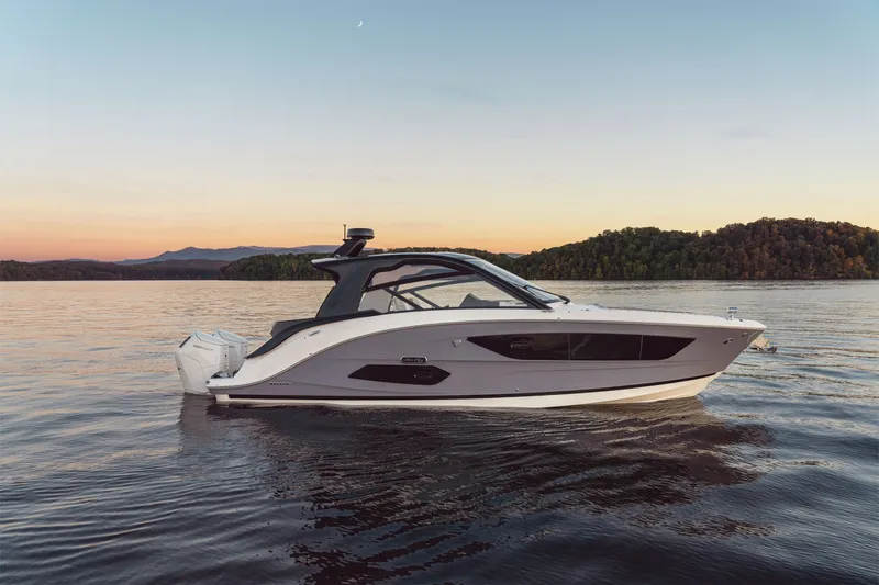 Slide: The Image of Sea Ray Sundancer 370 Outboard 2026 at sunset on calm water. - 3
