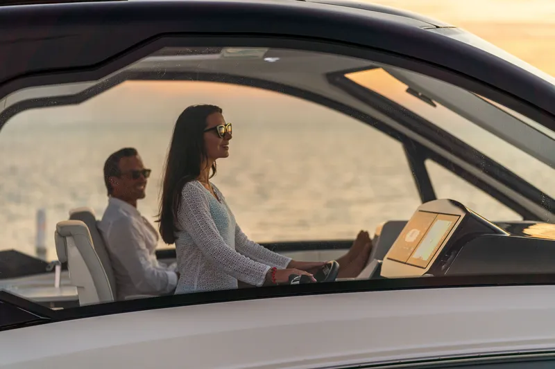 Slide: The Image of Two people enjoy the view on a Sea Ray Sundancer 370 Outboard at sunset. - 20