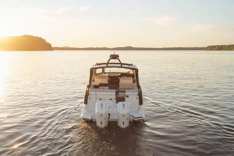 Slide: The Image of A 2026 Sea Ray Sundancer 370 Outboard on calm water at sunset. - 34