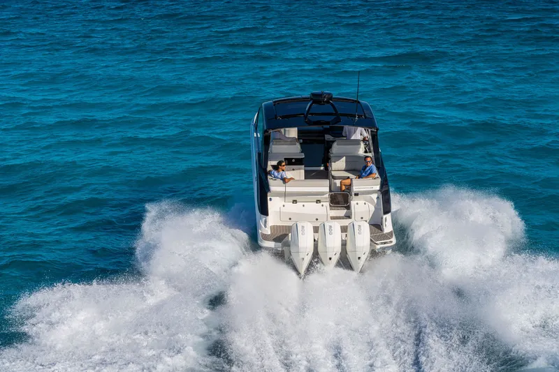 Slide: The Image of The 2026 Sea Ray Sundancer 370 Outboard speeds across the blue water. - 4