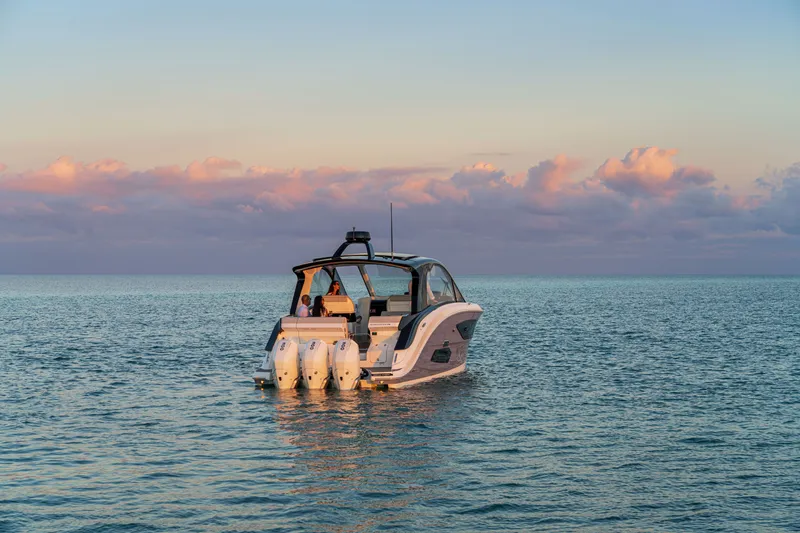 Slide: The Image of A 2026 Sea Ray Sundancer 370 Outboard on calm waters at sunset. - 23