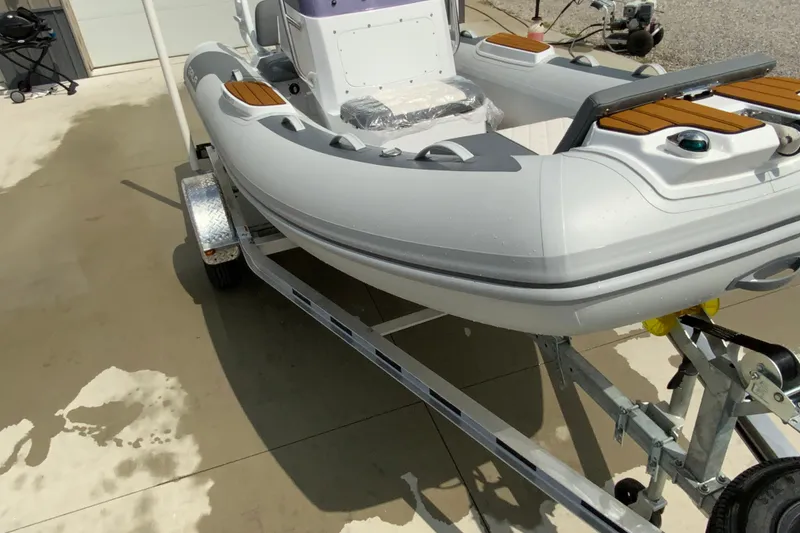 Slide: The Image of 2027 Gala V420 inflatable boat on trailer, featuring sleek design and modern fittings. - 4