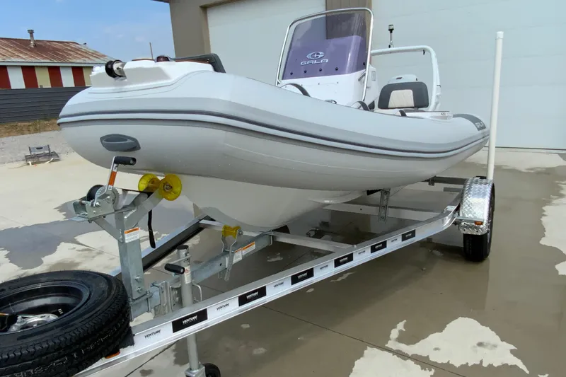 Slide: The Image of 2027 Gala V420 boat on trailer, parked outdoors, showcasing sleek design and modern features. - 7