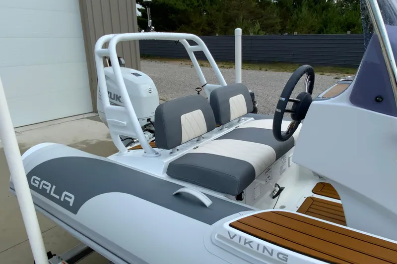Slide: The Image of 2027 Gala V420 boat with dual seats and Suzuki engine, parked outdoors. - 9