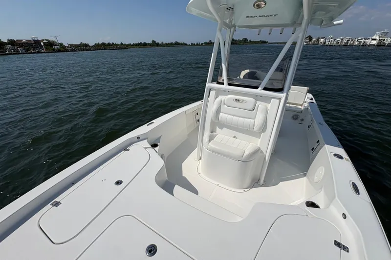Slide: The Image of 2017 Sea Hunt BX 25 BR boat on water, featuring spacious deck and seating. - 8