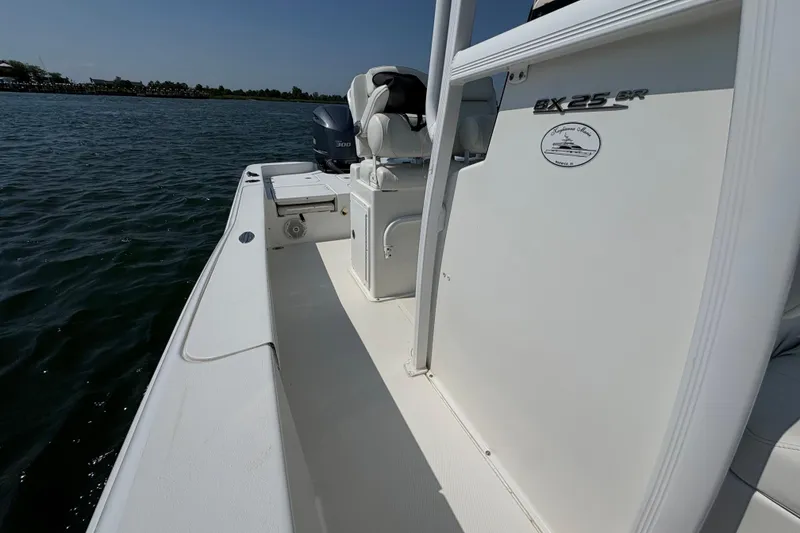 Slide: The Image of 2017 Sea Hunt BX 25 BR boat on water, showcasing deck and seating area. - 10