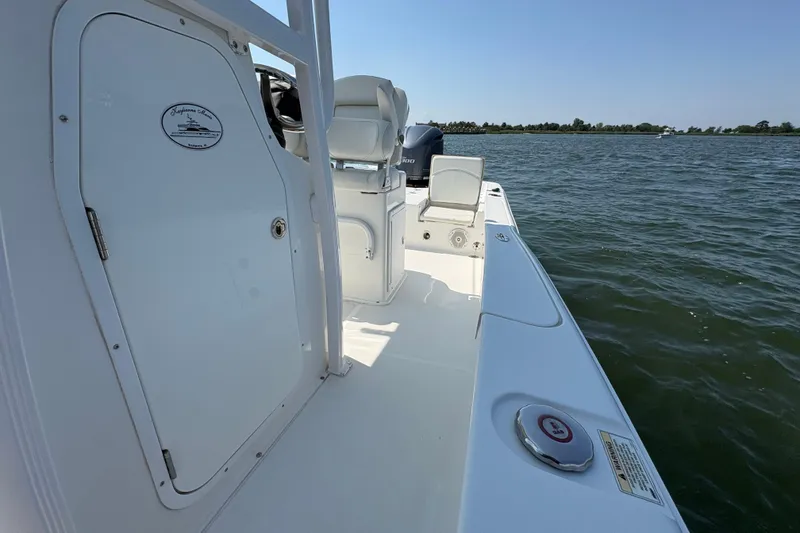 Slide: The Image of 2017 Sea Hunt BX 25 BR boat on water, showcasing deck and seating area. - 9
