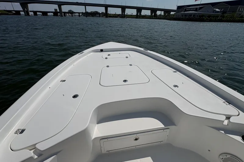 Slide: The Image of 2017 Sea Hunt BX 25 BR boat deck on calm water near a bridge. - 7