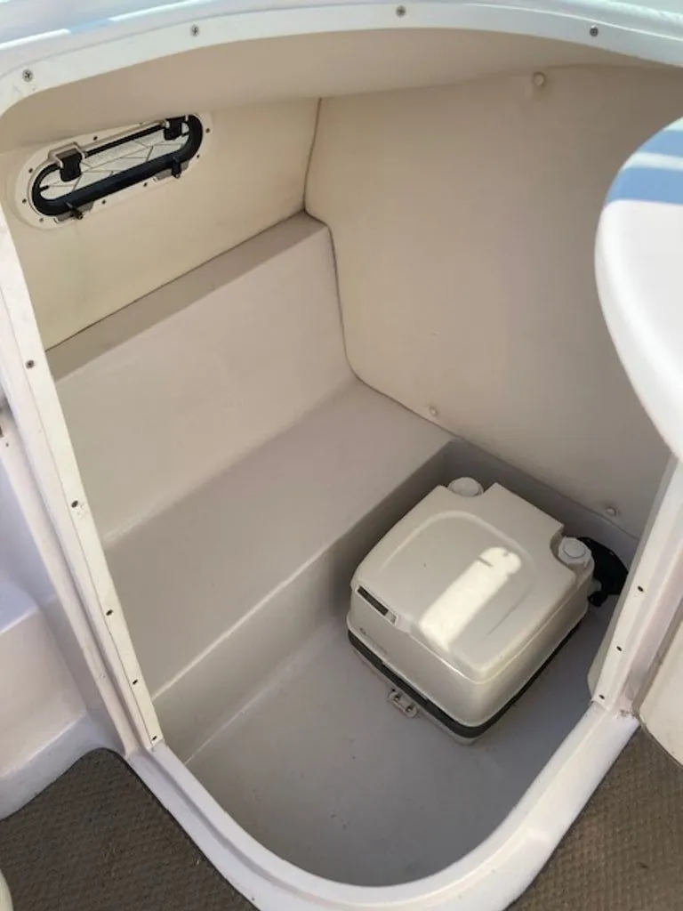 Slide: The Image of A compact toilet area with a portable toilet inside a boat. - 5