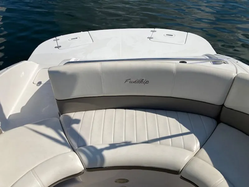 Slide: The Image of The image shows the stern of a 2003 Four Winns 214 Funship boat on the water. - 6