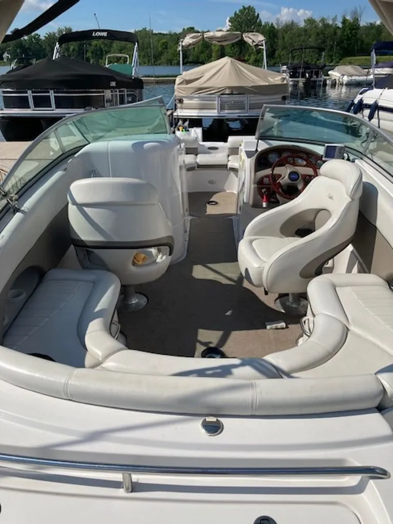 Slide: The Image of The image shows the cockpit of a 2003 Four Winns 214 Funship with white seating and a wood steering wheel. - 3