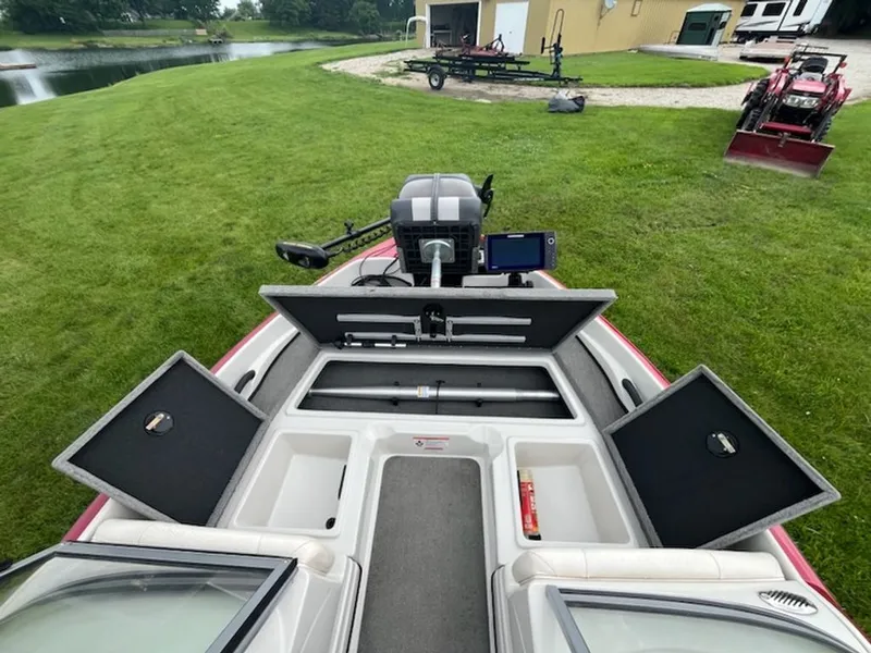 Slide: The Image of The image shows the deck of a 2015 Nitro Z-7 Sport boat with open storage compartments. - 12