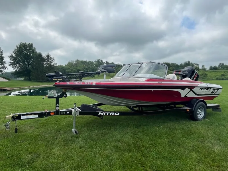 Slide: The Image of A red 2015 Nitro Z-7 Sport boat on a trailer, parked on grass. - 26