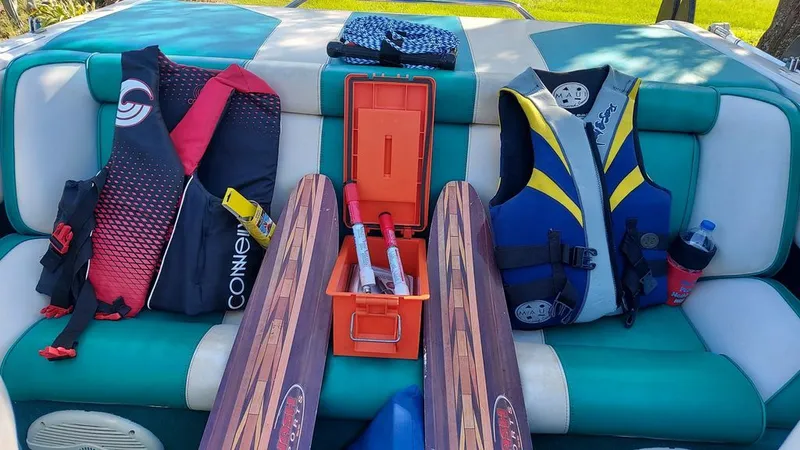 Slide: The Image of Interior view of a boat with water skis, life jackets, and accessories on the seats. - 5