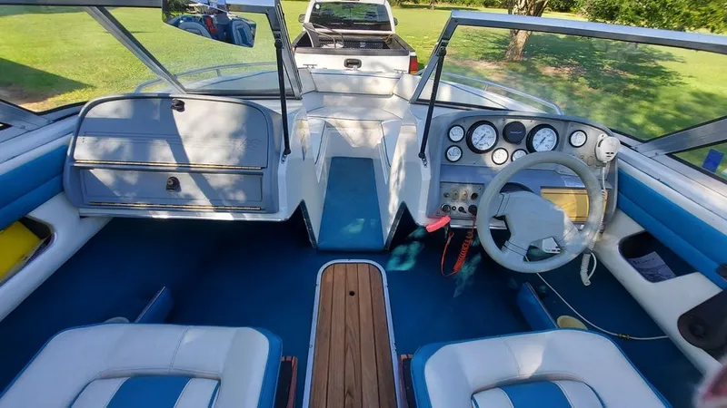 Slide: The Image of Interior view of a 1992 Four Winns 190 Horizon with blue and white seating and dashboard. - 2