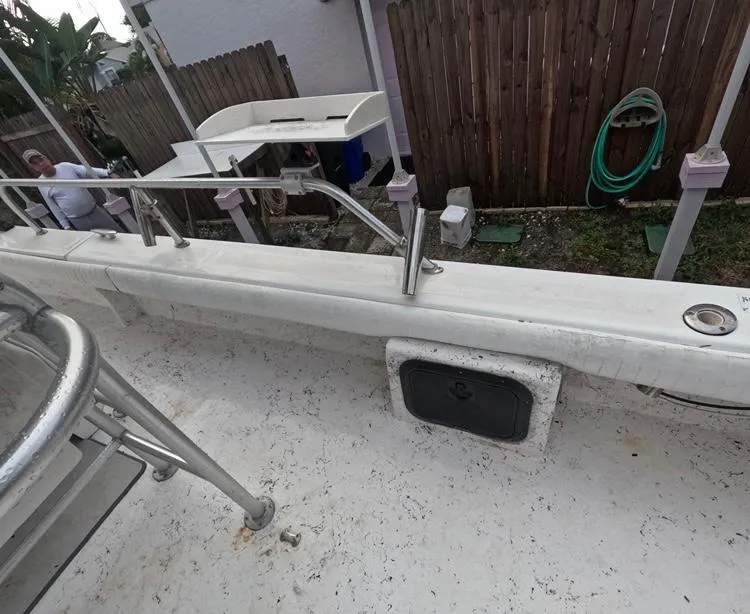 Slide: The Image of 2004 Twin Vee 26 Center Console boat deck with railing and storage compartment. - 38
