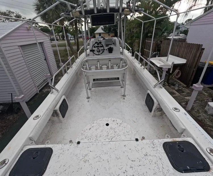 Slide: The Image of 2004 Twin Vee 26 Center Console boat with spacious deck and fishing rod holders. - 12