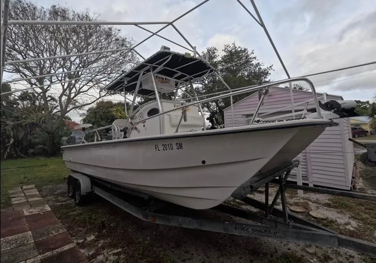 Slide: The Image of 2004 Twin Vee 26 Center Console boat on trailer, parked outdoors. - 8