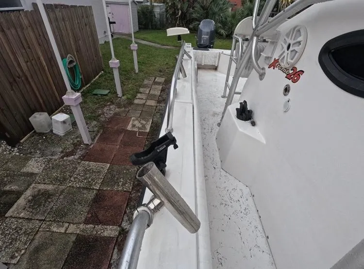 Slide: The Image of 2004 Twin Vee 26 Center Console boat, side view, showing deck and railing. - 30