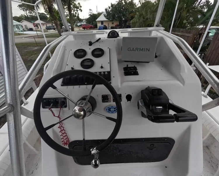 Slide: The Image of 2004 Twin Vee 26 Center Console boat dashboard with Garmin navigation system. - 16