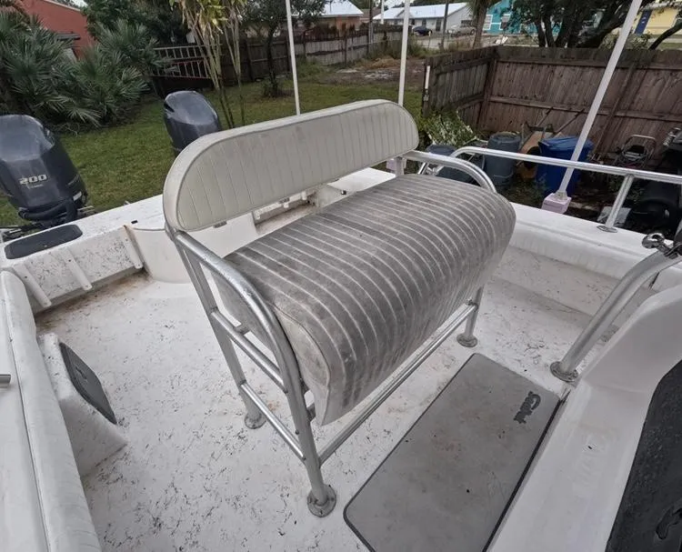 Slide: The Image of 2004 Twin Vee 26 Center Console boat interior with seating and dual engines. - 33