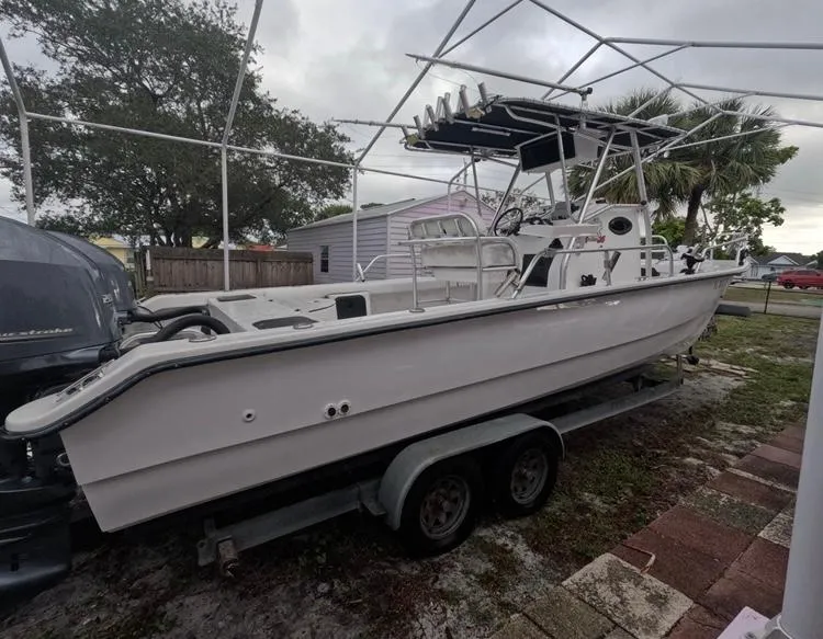Slide: The Image of 2004 Twin Vee 26 Center Console boat on trailer, parked outdoors. - 6