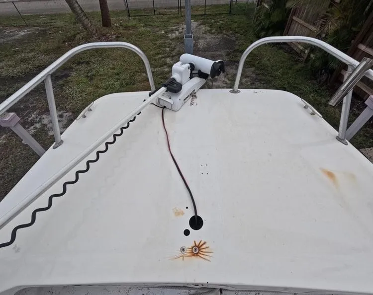 Slide: The Image of 2004 Twin Vee 26 Center Console boat deck with mounted equipment and visible rust marks. - 25