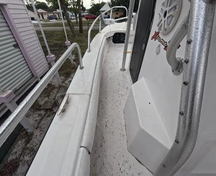 Slide: The Image of 2004 Twin Vee 26 Center Console boat deck with railings and speaker. - 19