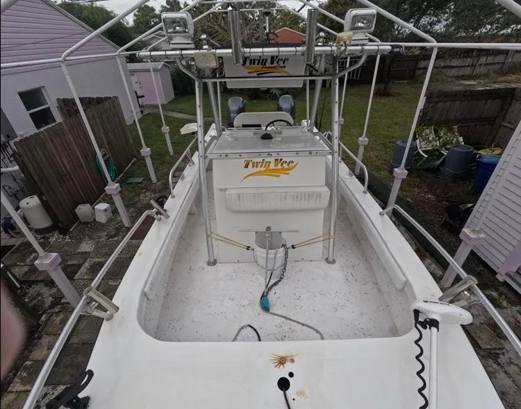Slide: The Image of 2004 Twin Vee 26 Center Console boat with spacious deck and fishing equipment. - 26
