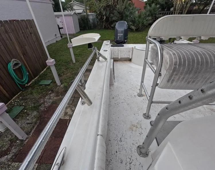 Slide: The Image of 2004 Twin Vee 26 Center Console boat interior with seating and railing. - 32