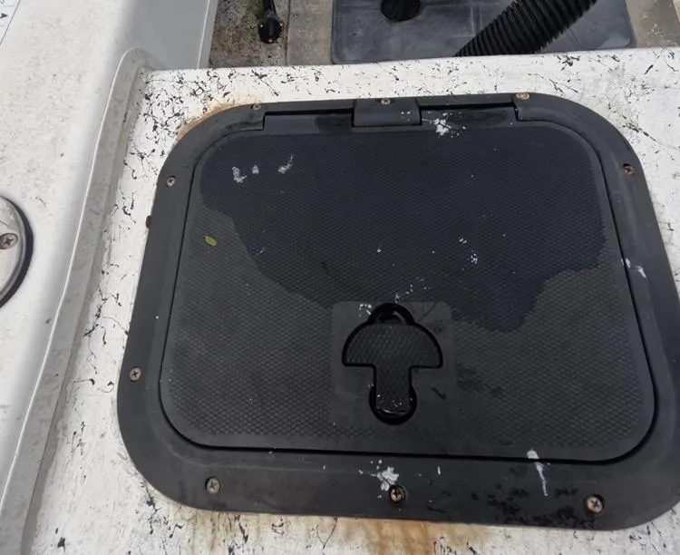 Slide: The Image of 2004 Twin Vee 26 Center Console boat hatch with wear and stains. - 45