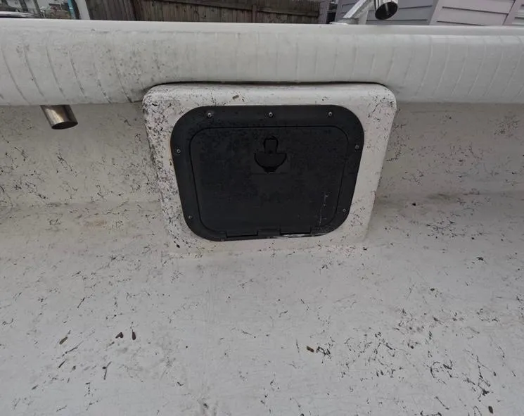 Slide: The Image of 2004 Twin Vee 26 Center Console boat hatch with weathered surface. - 35