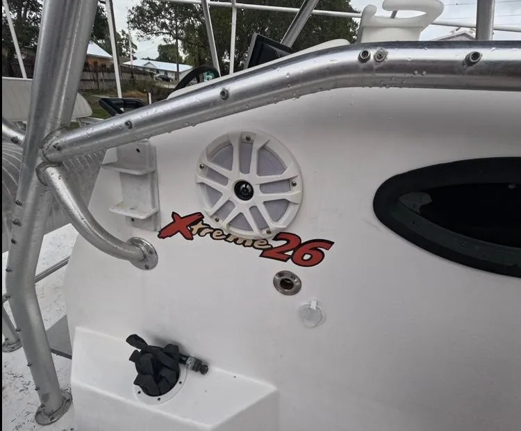 Slide: The Image of 2004 Twin Vee 26 Center Console boat with Xtreme 26 logo and speaker detail. - 31