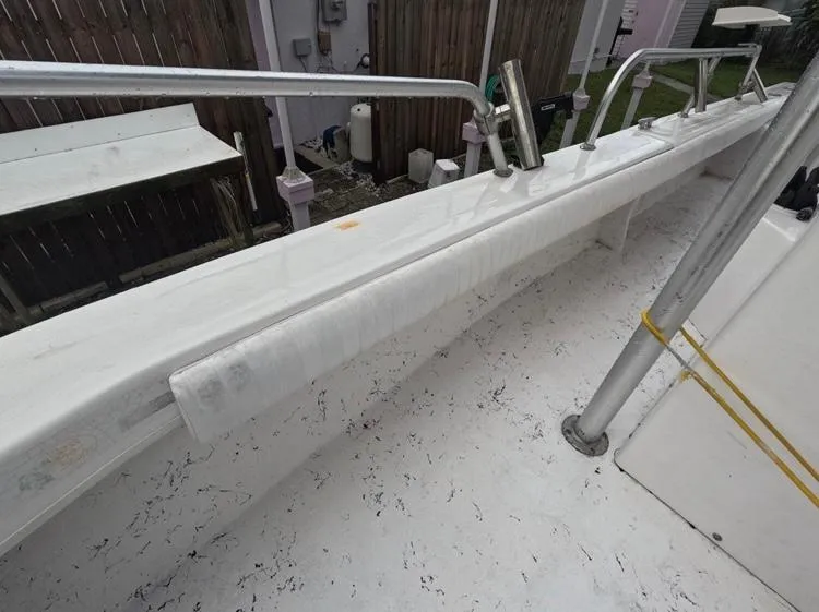 Slide: The Image of 2004 Twin Vee 26 Center Console boat deck with railing and textured flooring. - 29