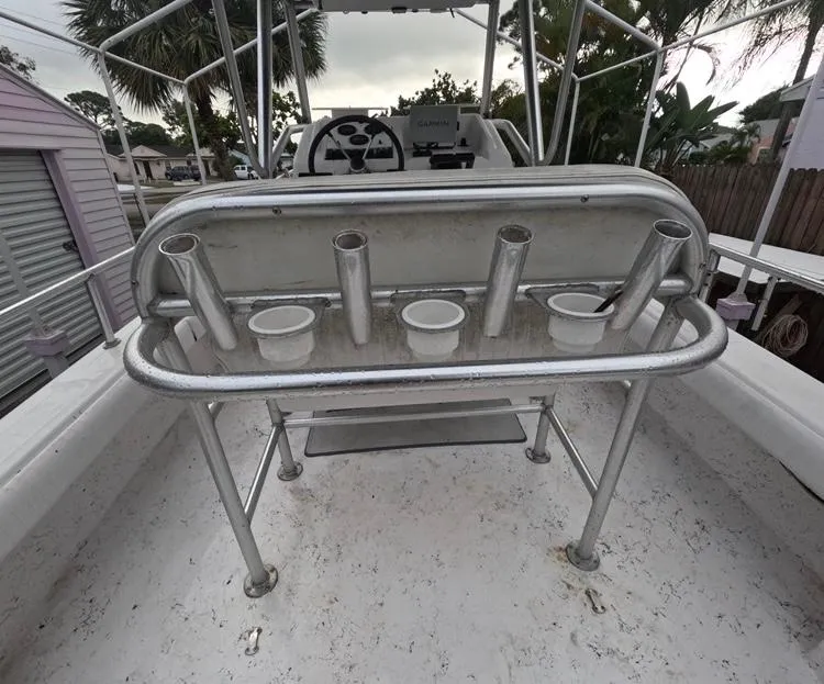 Slide: The Image of 2004 Twin Vee 26 Center Console boat with rod holders and storage compartments. - 14