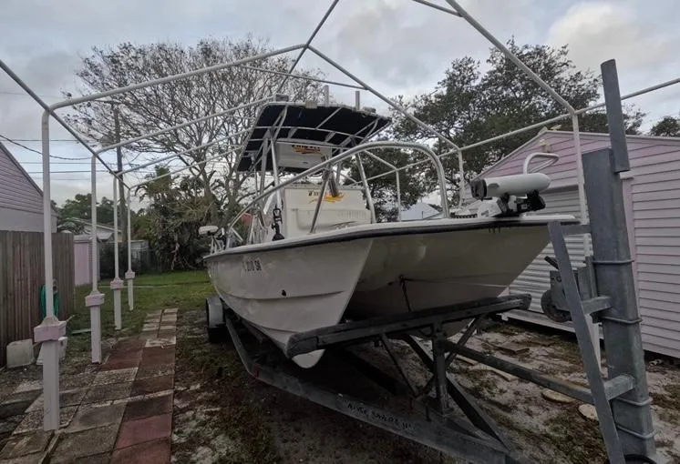 Slide: The Image of 2004 Twin Vee 26 Center Console boat on trailer, parked outdoors. - 9