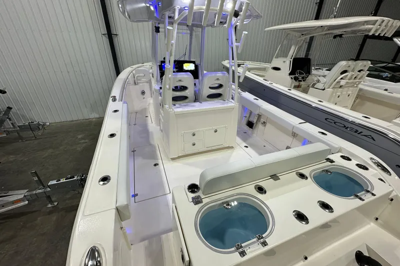 Slide: The Image of 2024 Cobia 301 Center Console boat interior with seating and fishing amenities. - 3