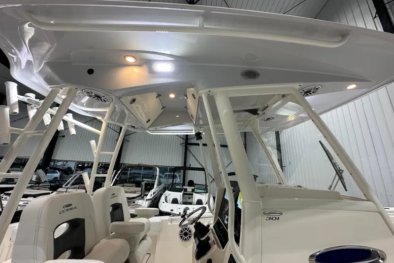 Slide: The Image of 2024 Cobia 301 Center Console boat interior with seating and overhead lighting. - 13