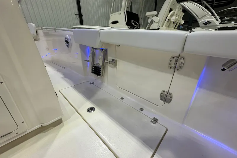 Slide: The Image of 2024 Cobia 301 Center Console boat interior with sleek design and blue LED lighting. - 7