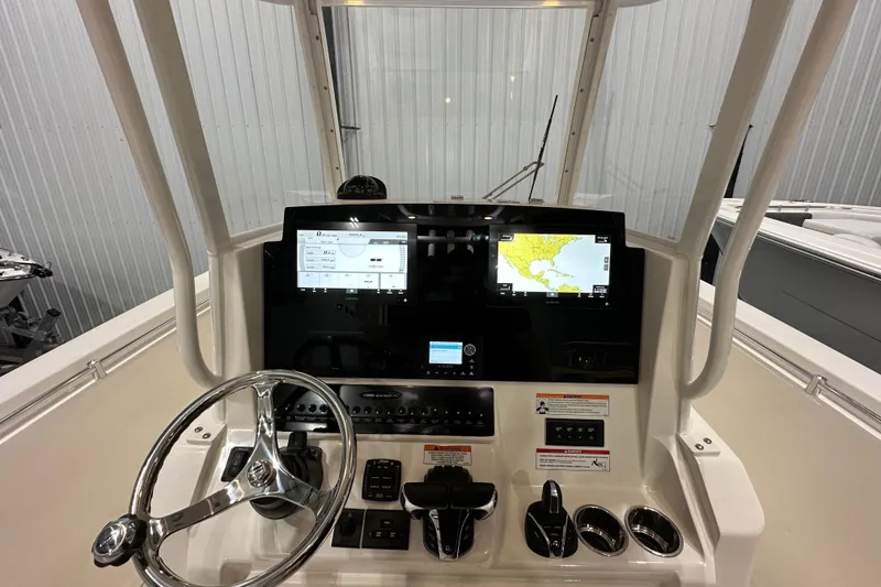 Slide: The Image of 2024 Cobia 301 Center Console helm with navigation screens and controls. - 9