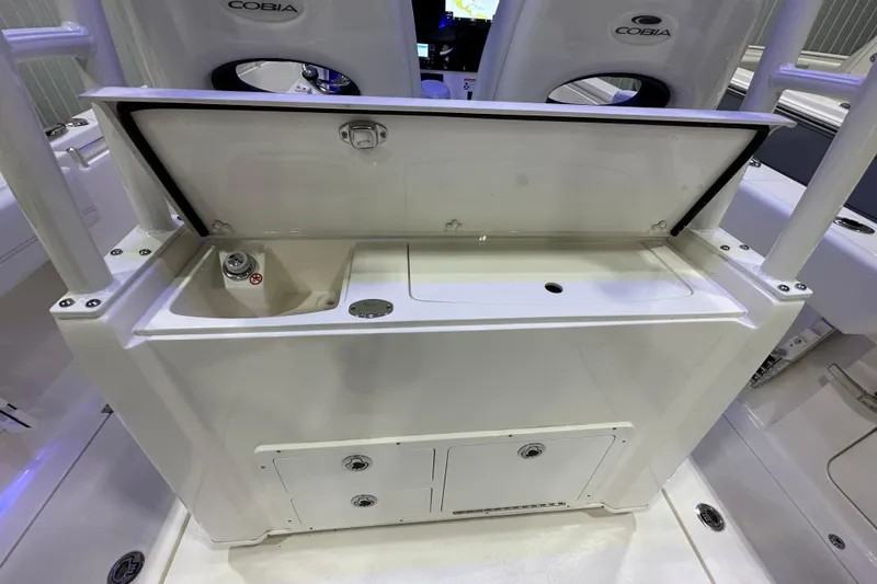 Slide: The Image of 2024 Cobia 301 Center Console boat with open storage compartment and seating. - 6
