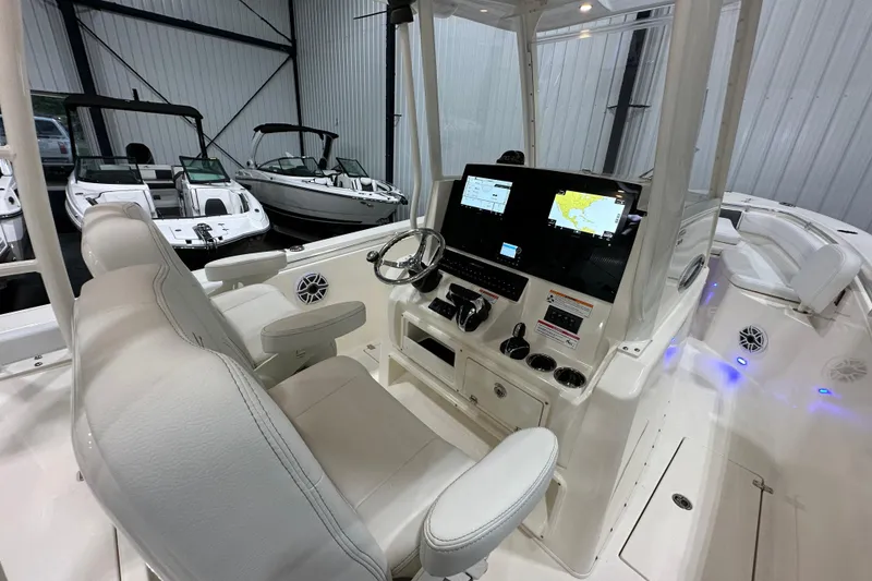 Slide: The Image of 2024 Cobia 301 Center Console boat interior with modern navigation system and comfortable seating. - 8