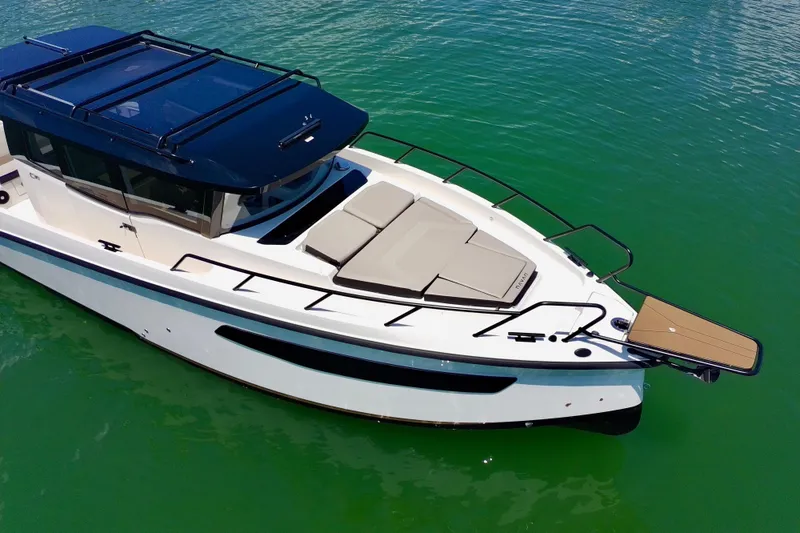 Slide: The Image of 2026 Navan C30 boat on clear green water, featuring sleek design and spacious deck. - 7